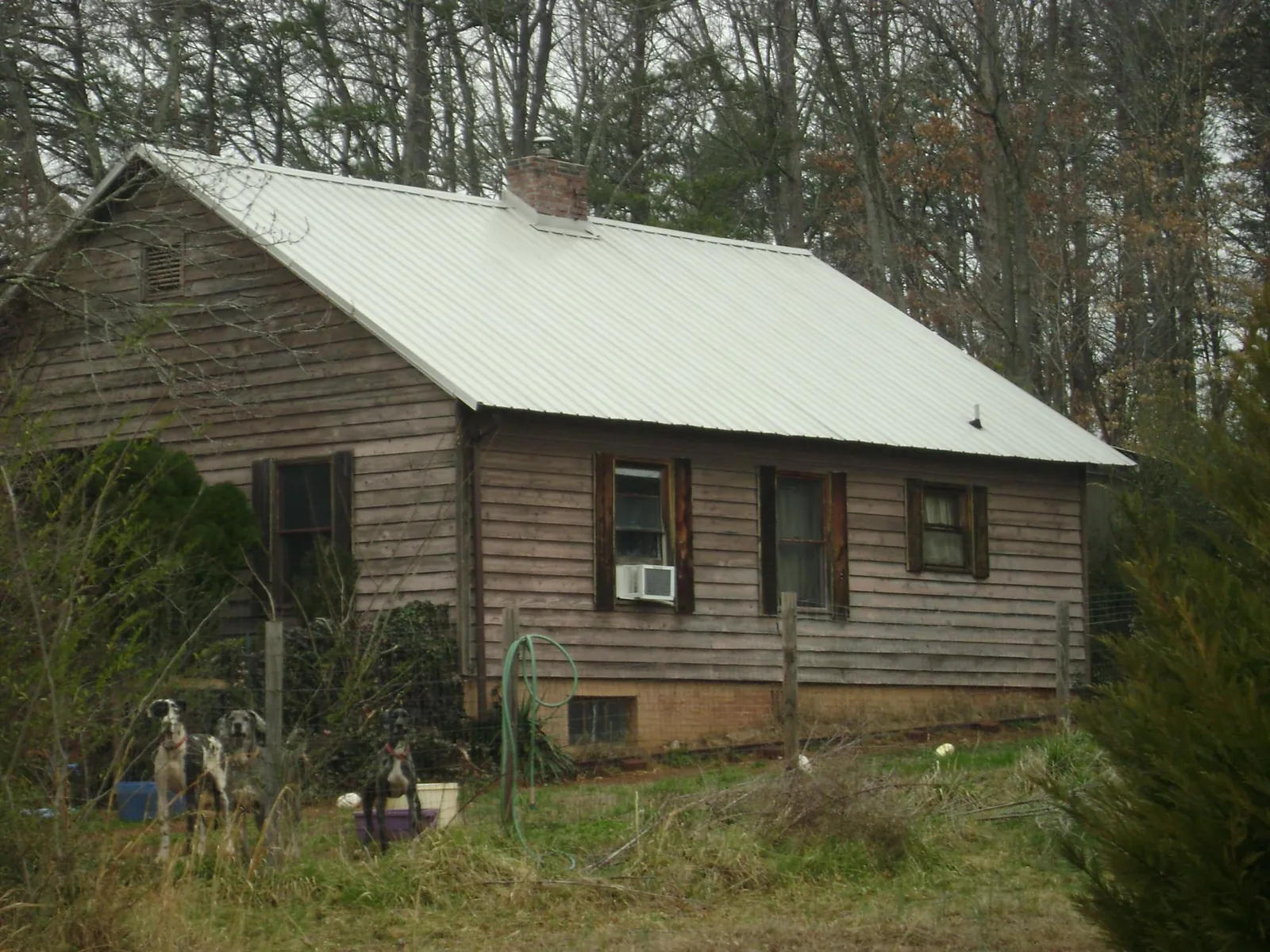 White metal roof on an old wood sided farmhouse, from a Metal Roof Installation job in Audubon